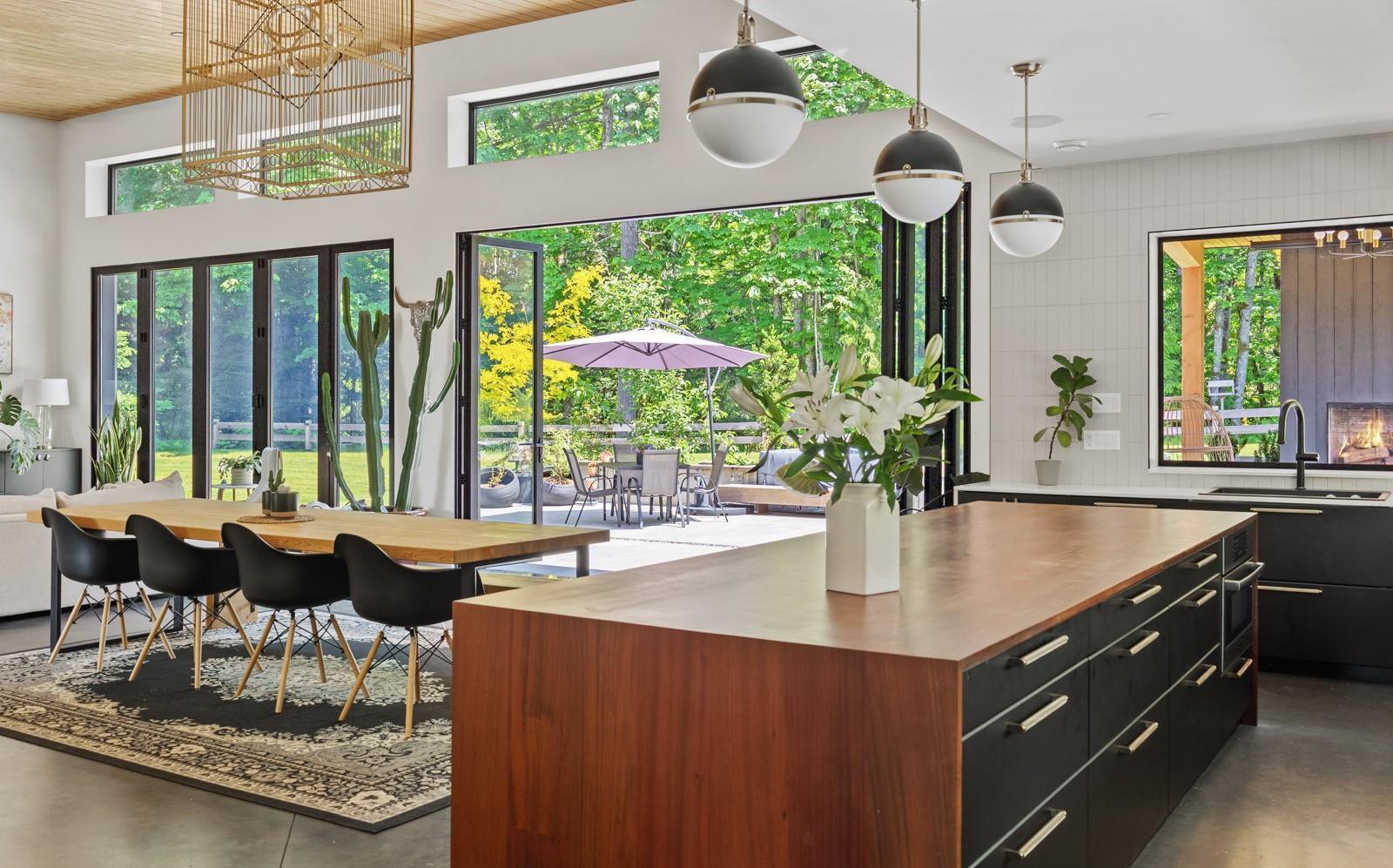 Walnut waterfall island with folding doors onto the terrace